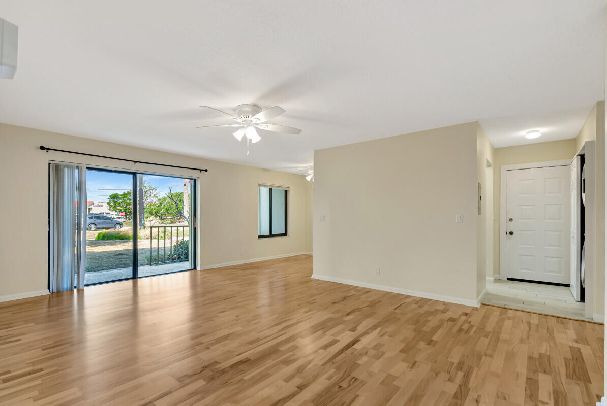 150 Pineview Road, Unit B2 Jupiter, FL 33469 - Photo 3 of 13 an empty room with wooden floor and windows