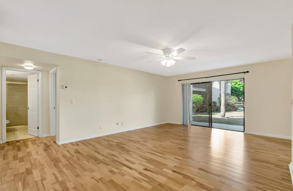 150 Pineview Road, Unit B2 Jupiter, FL 33469 - Photo 4 of 13 a view of empty room with wooden floor and fan