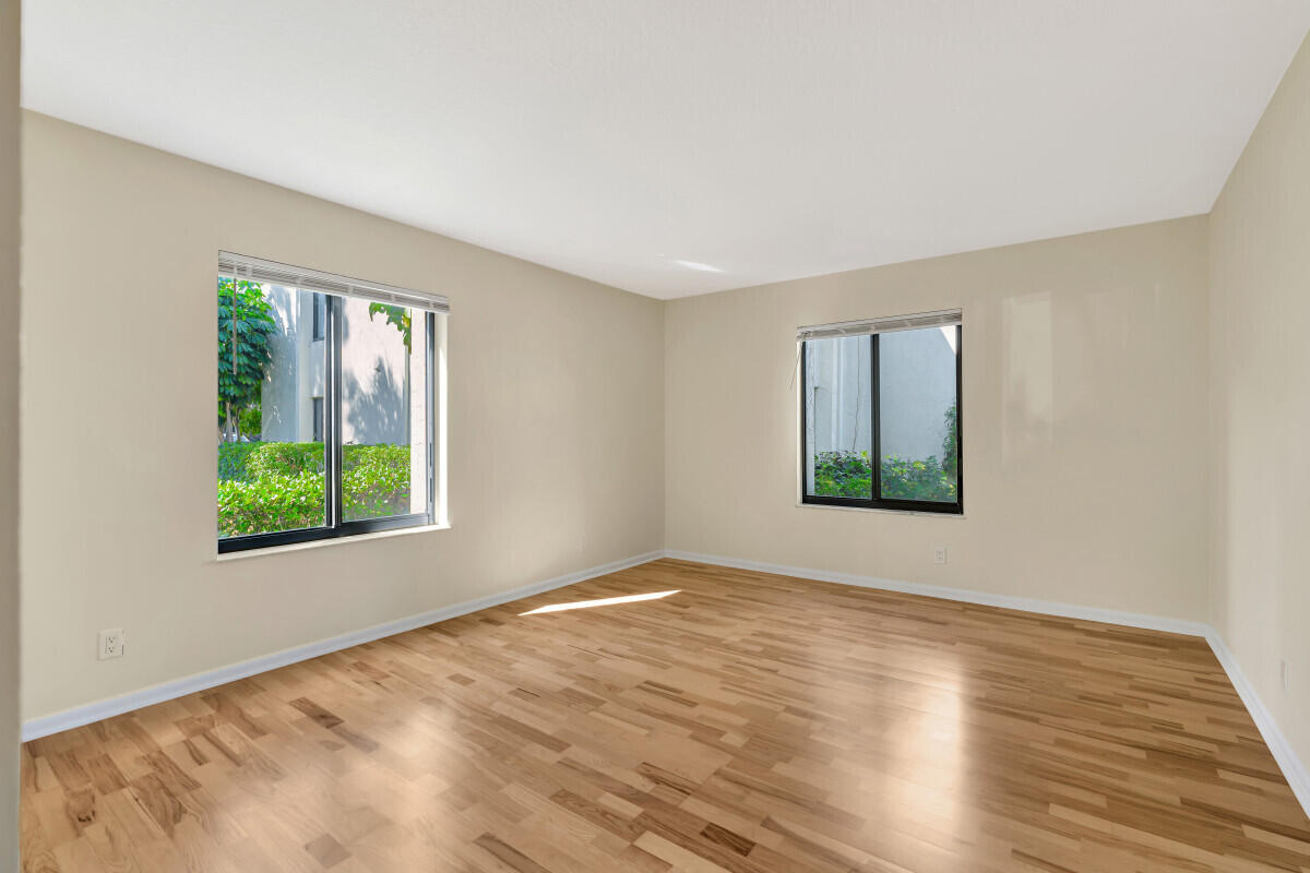 150 Pineview Road, Unit B2 Jupiter, FL 33469 - Photo 9 of 13 a view of an empty room with wooden floor and a window