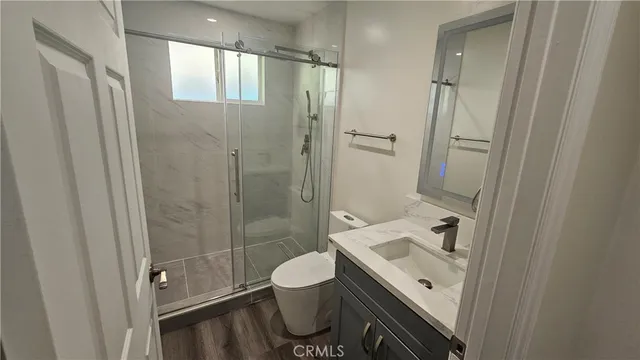 a view of a room with wooden floor