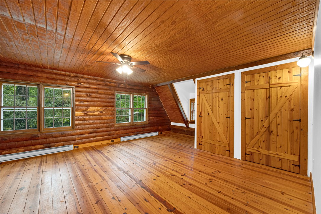 237 Spring Valley Road Liberty, SC 29657 - Photo 18 of 50 Natural wood textures enhance this room, featuring rustic plank walls and polished wood floors.