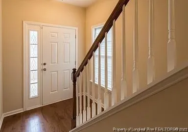 a view of an entryway with wooden floor