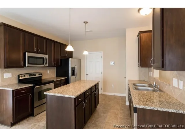 a kitchen with a stove sink and microwave