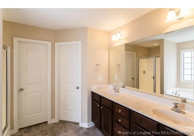 a bathroom with double sink and a mirror