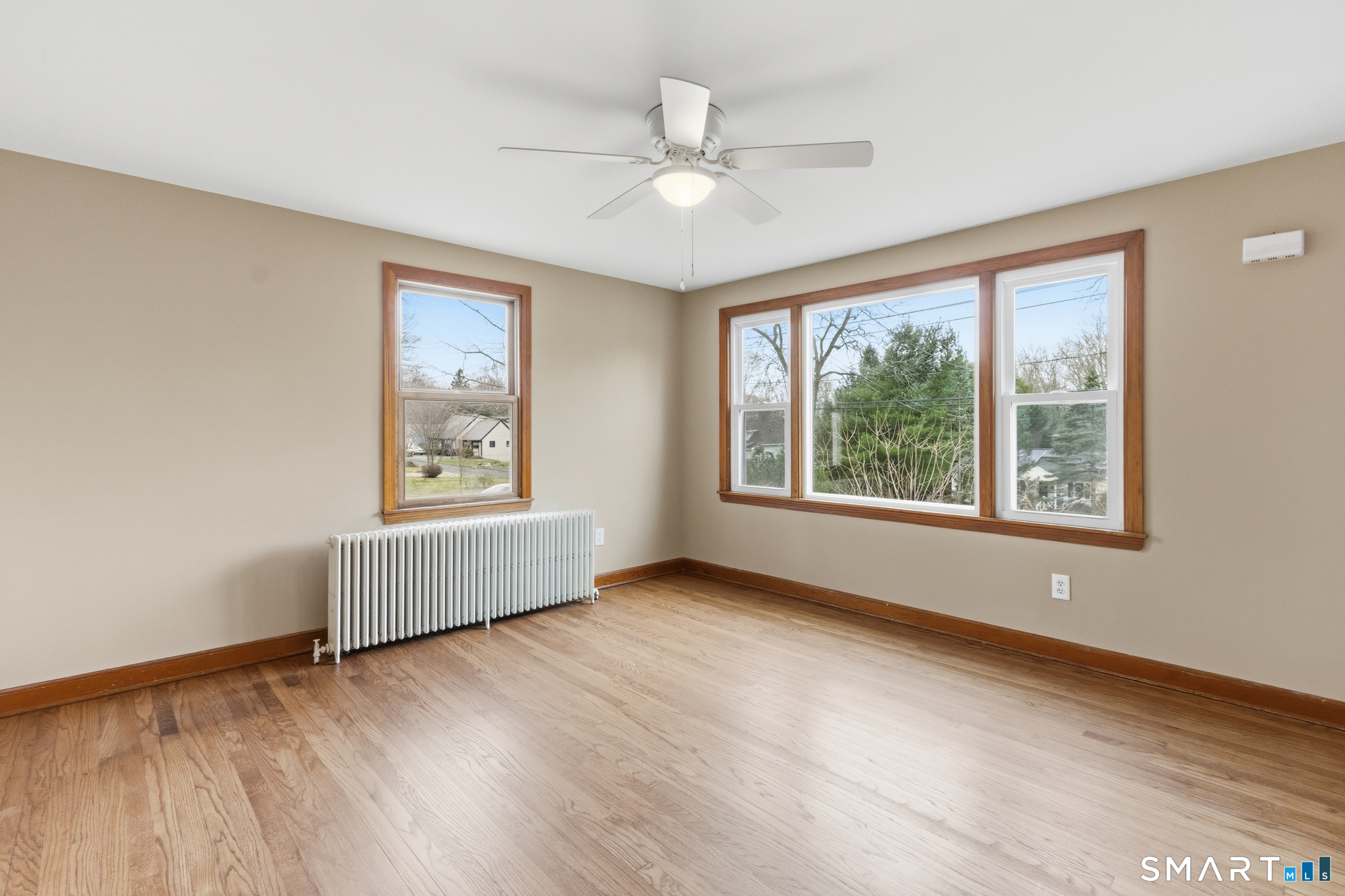 217 East Waterbury Road Naugatuck, CT 06770 - Photo 13 of 38 a view of an empty room with wooden floor and a window