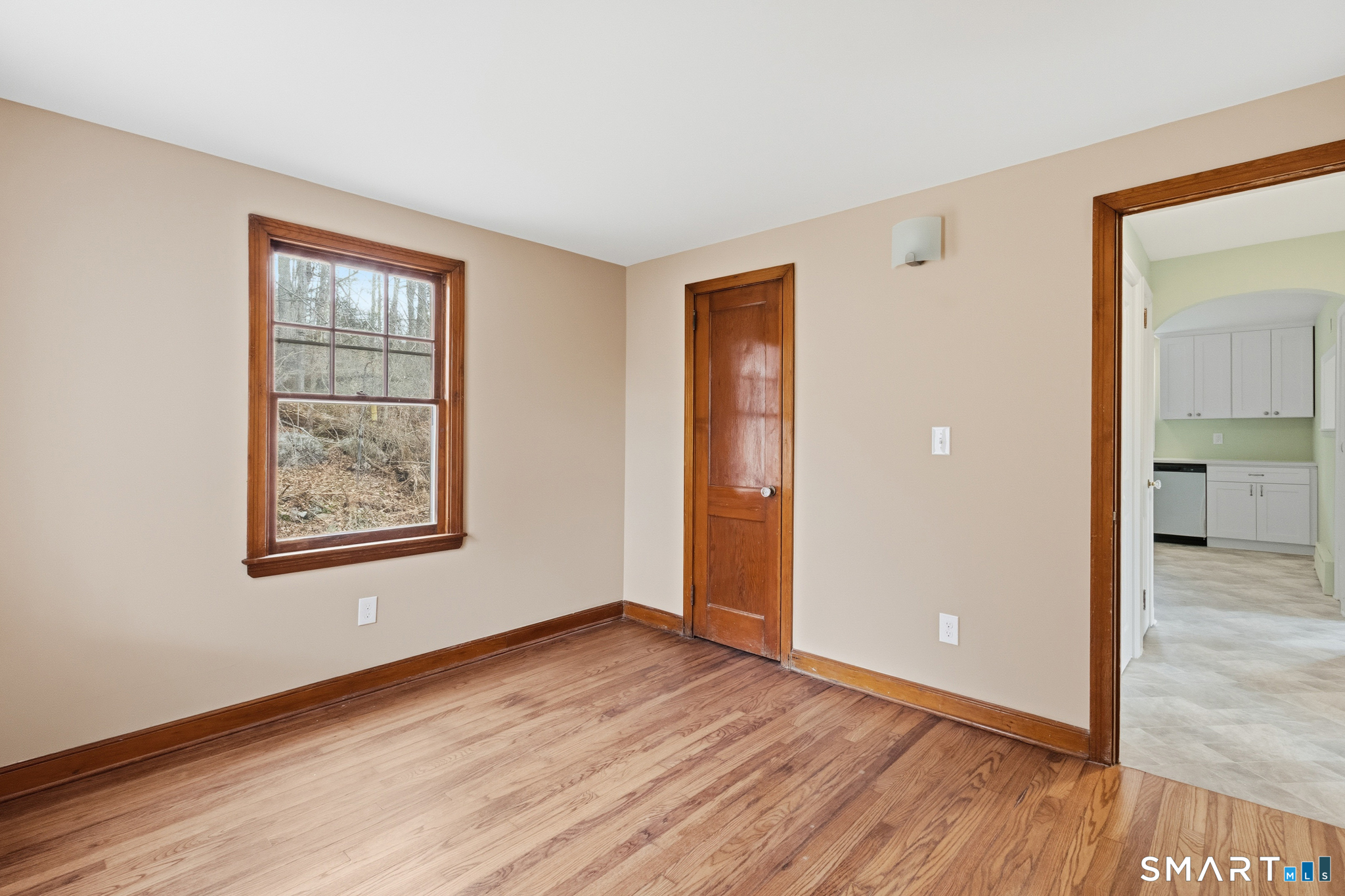 217 East Waterbury Road Naugatuck, CT 06770 - Photo 15 of 38 a view of an empty room with wooden floor and a window