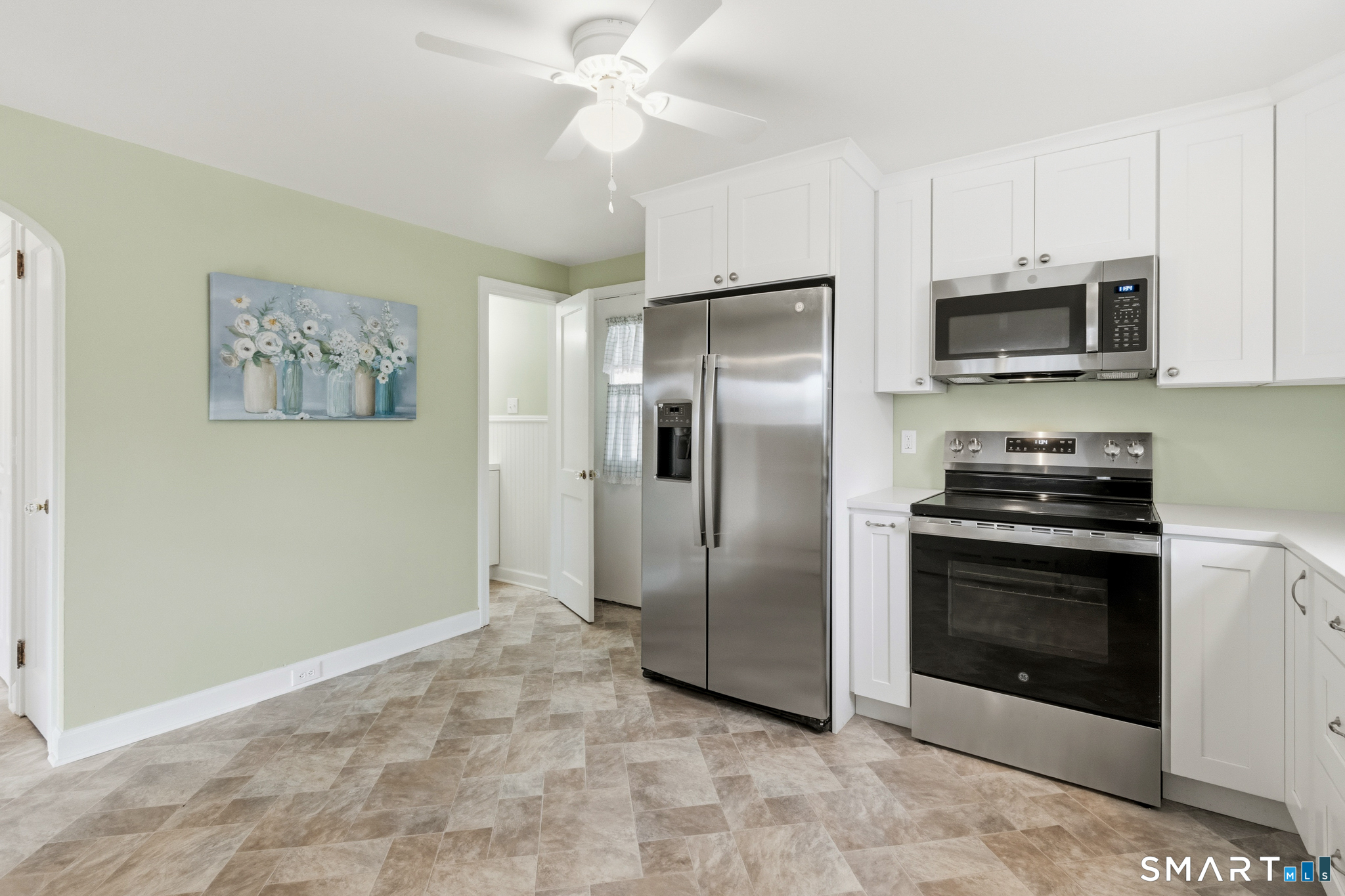 217 East Waterbury Road Naugatuck, CT 06770 - Photo 4 of 38 a kitchen with stainless steel appliances granite countertop a refrigerator a stove a microwave oven with white cabinets