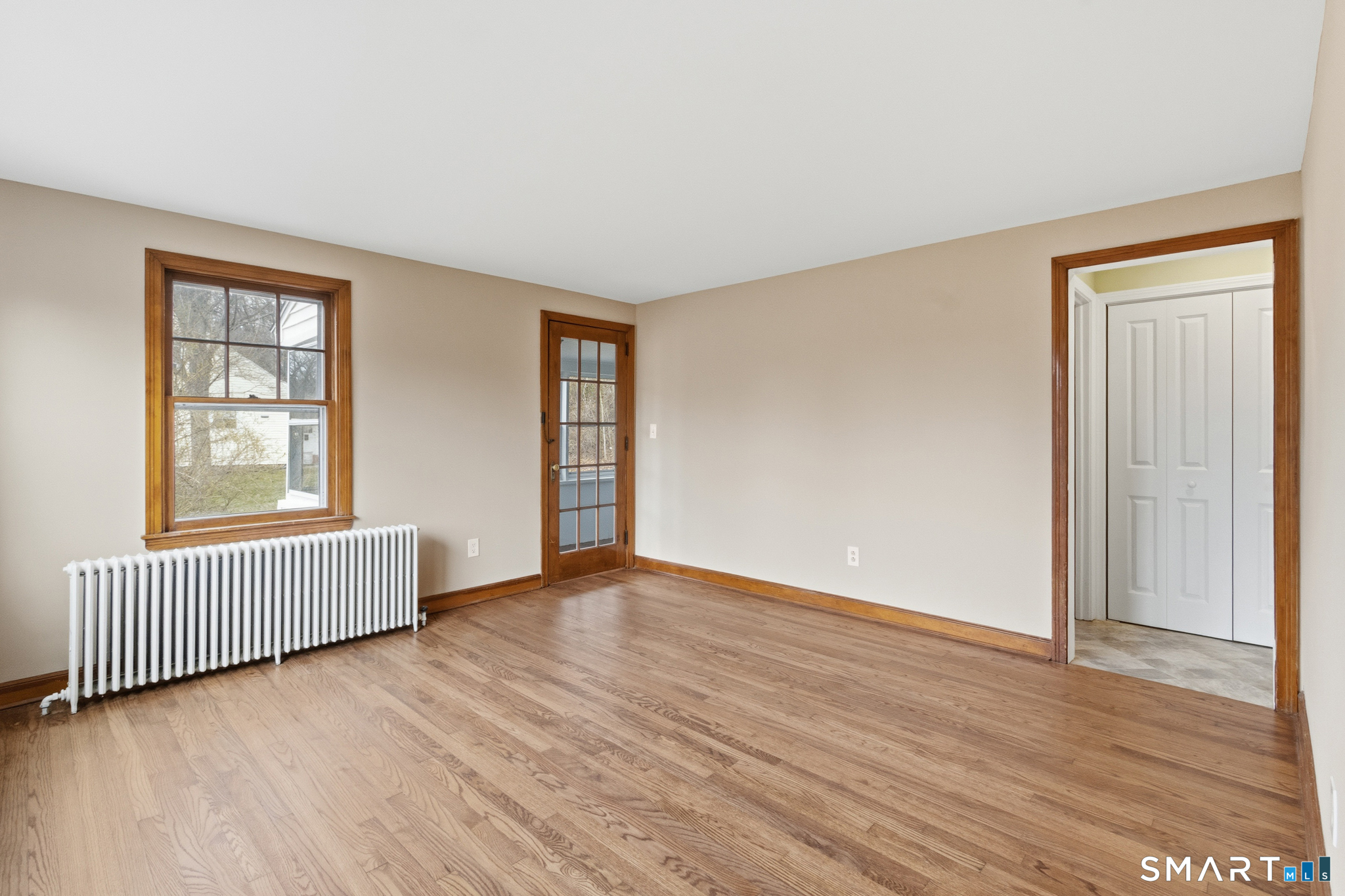 217 East Waterbury Road Naugatuck, CT 06770 - Photo 7 of 38 an empty room with wooden floor and windows
