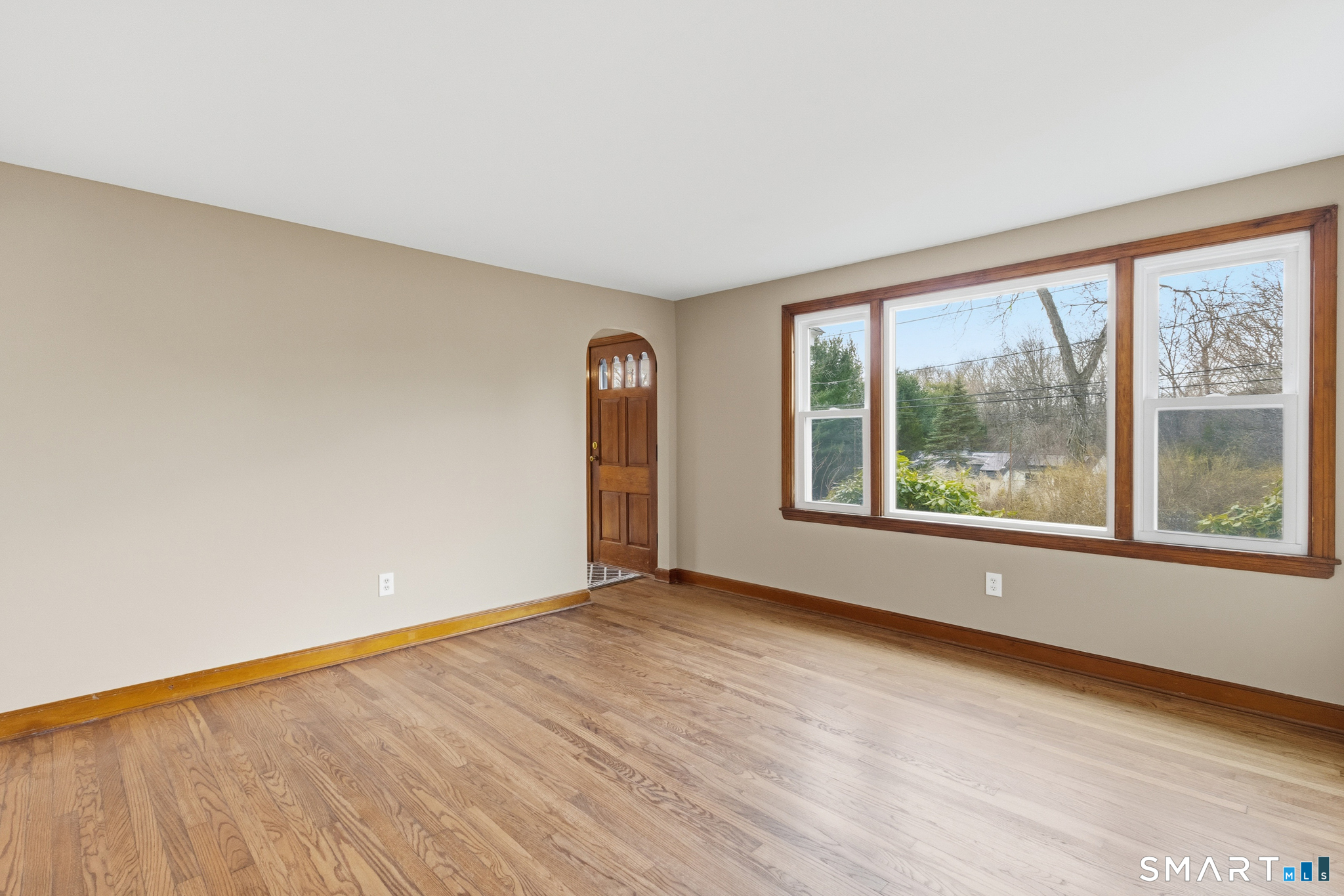 217 East Waterbury Road Naugatuck, CT 06770 - Photo 9 of 38 an empty room with wooden floor and windows