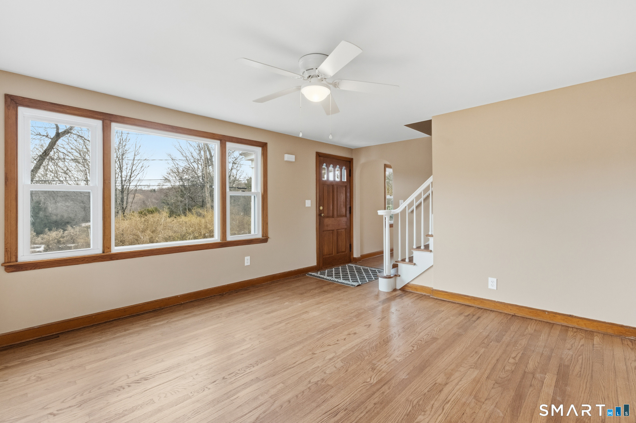 217 East Waterbury Road Naugatuck, CT 06770 - Photo 10 of 38 a view of an empty room with a window and wooden floor
