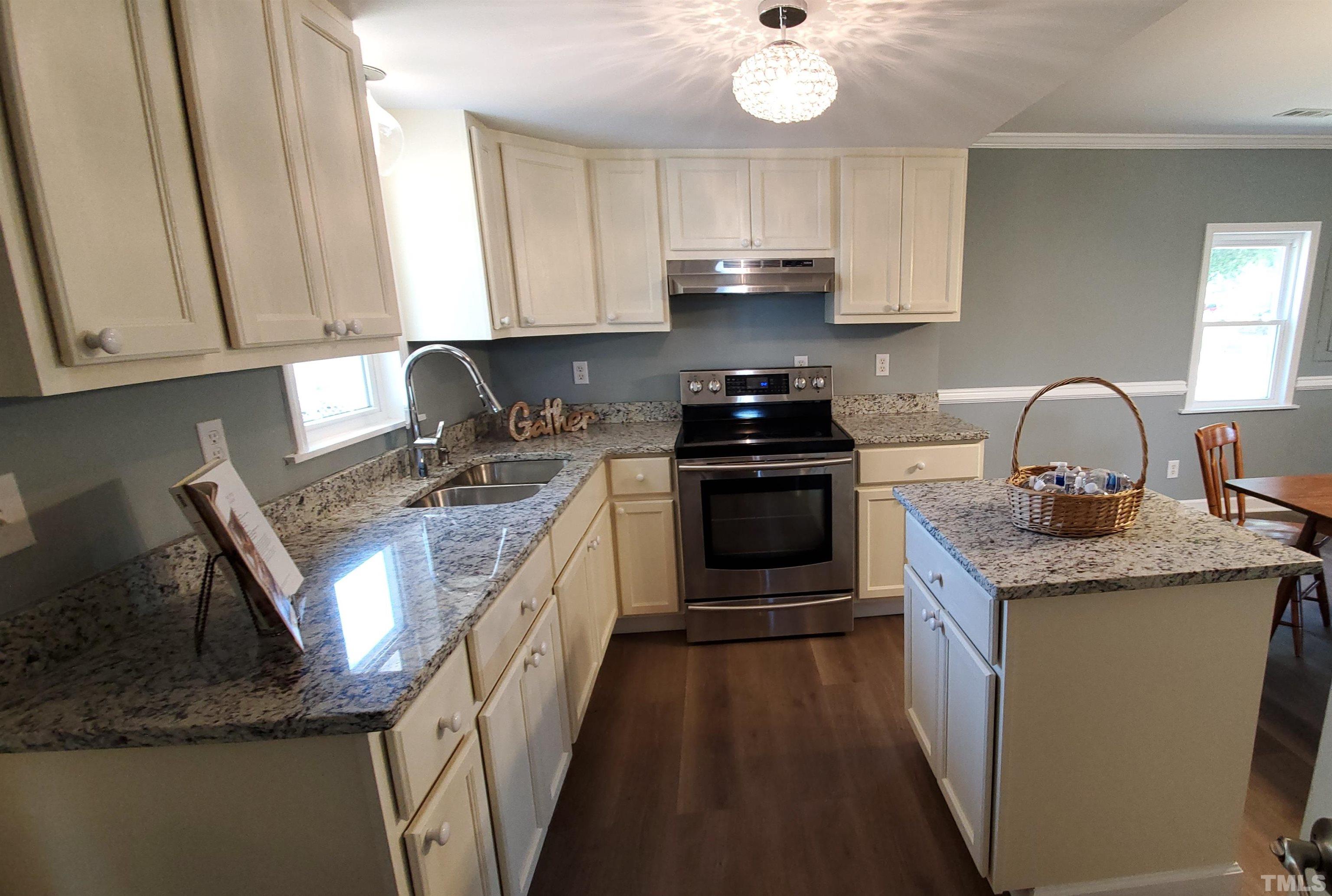 810 Raiford Road Erwin, NC 28339 - Photo 10 of 19 This kitchen boasts new cabinets, granite countertops, an island and a window overlooking the double sink.