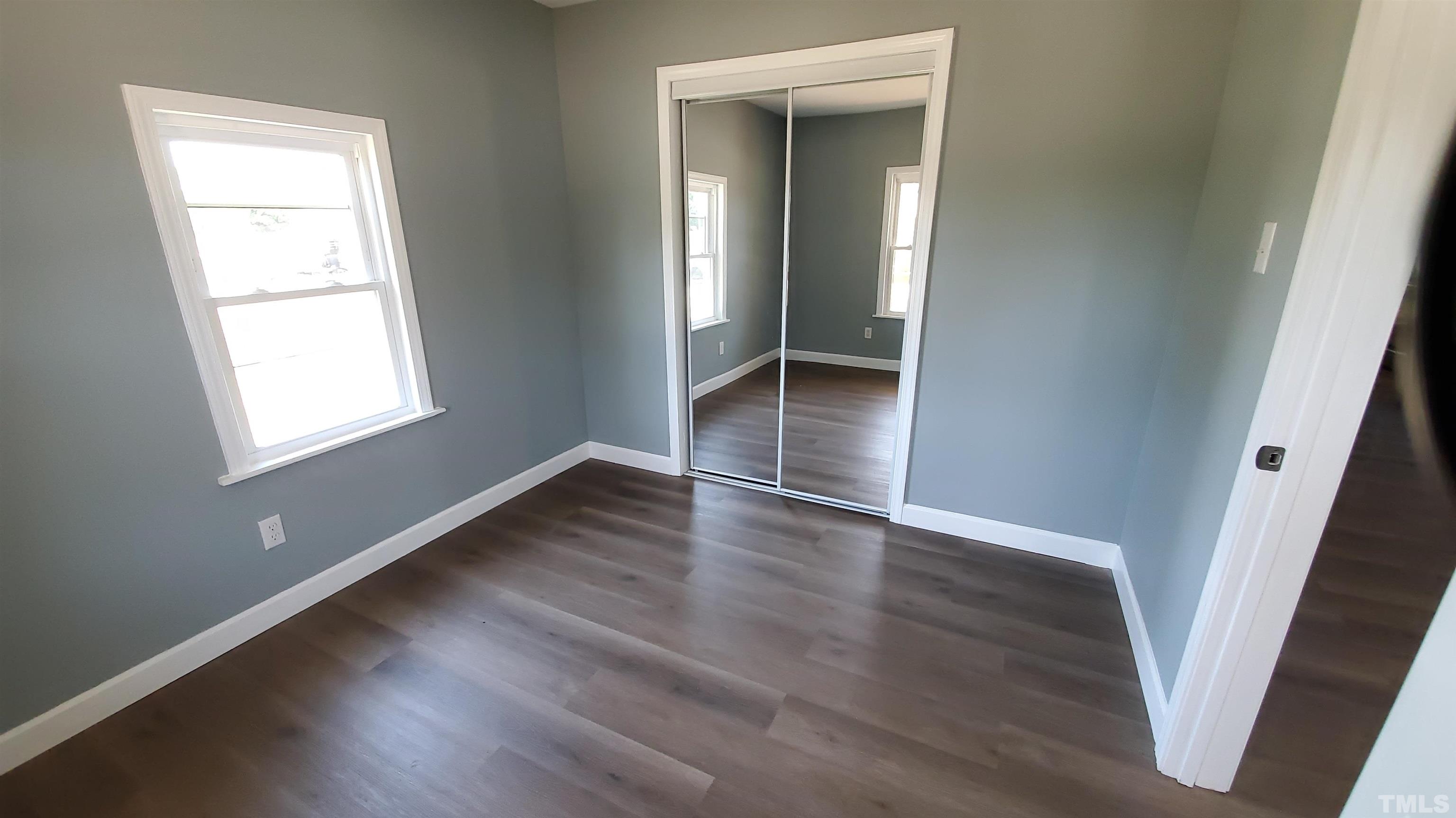810 Raiford Road Erwin, NC 28339 - Photo 4 of 19 This front bedroom has two new windows to bring in the natural light, new paint, new flooring and a mirrored closet door.