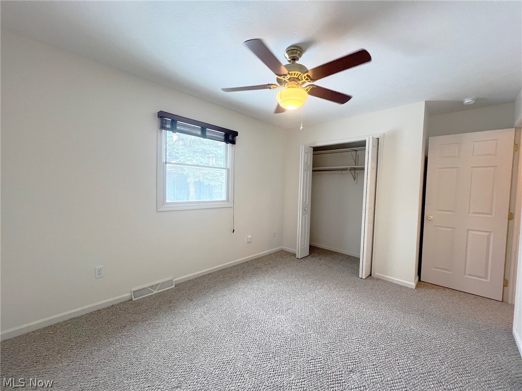 5203 Ridgeland Street Lorain, OH 44055 - Photo 10 of 39 Unfurnished bedroom with light colored carpet, a closet, and ceiling fan