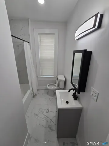 a view of a bathroom with sink and mirror
