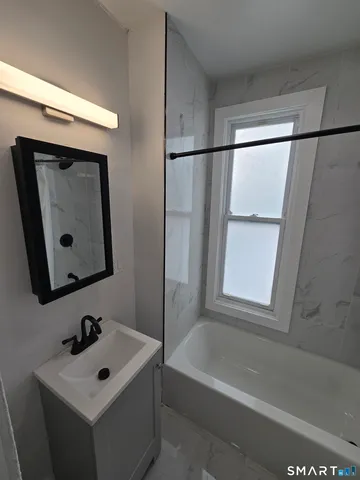 a bathroom with a bathtub and a sink