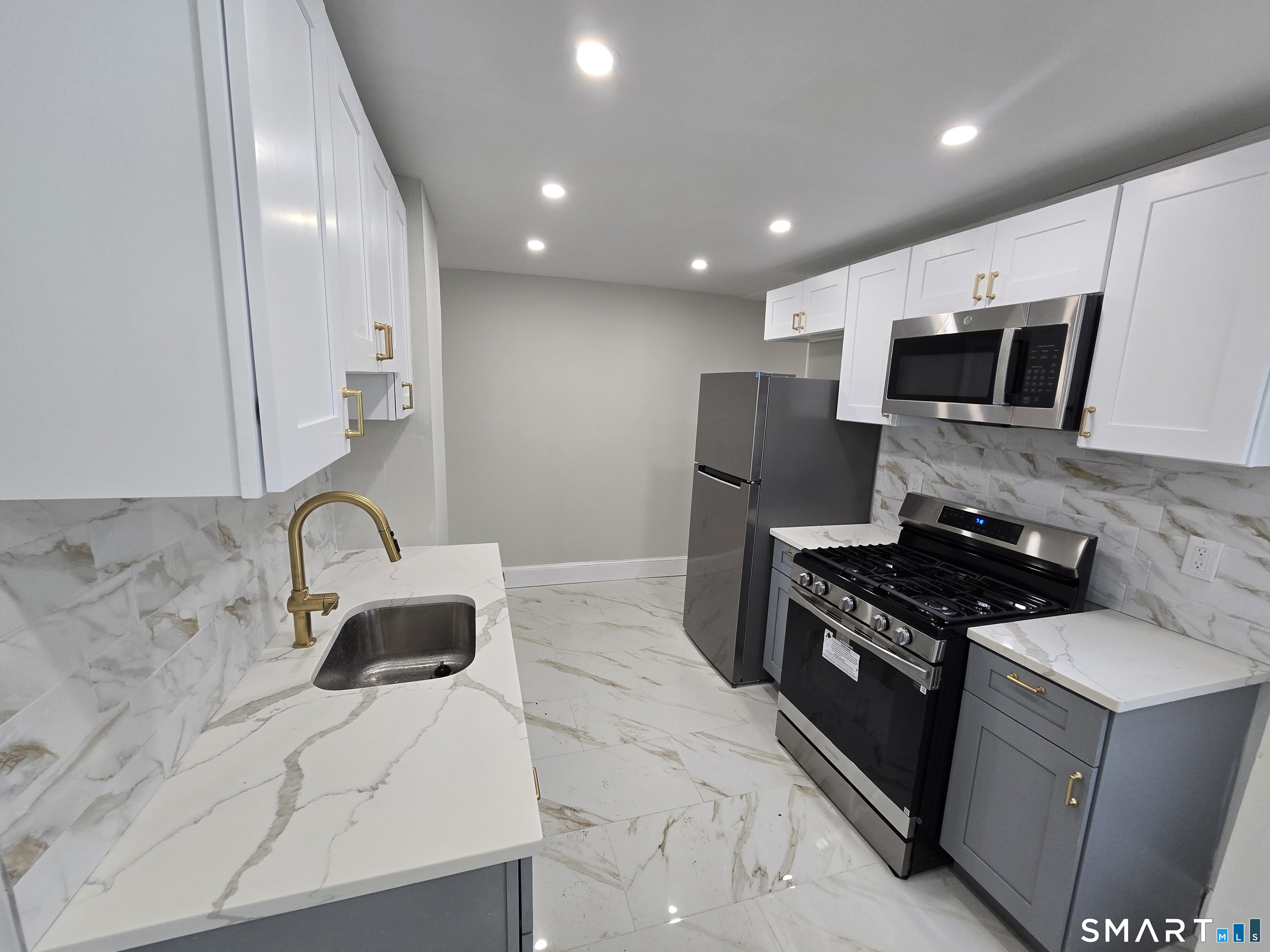 80 Dickerman Street New Haven, CT 06511 - Photo 16 of 31 a kitchen with stainless steel appliances granite countertop a stove a sink and a microwave