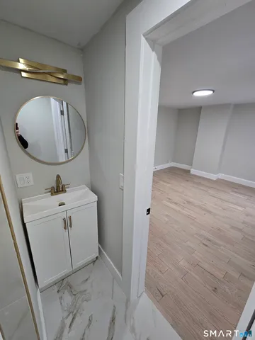 a bathroom with a sink mirror and vanity