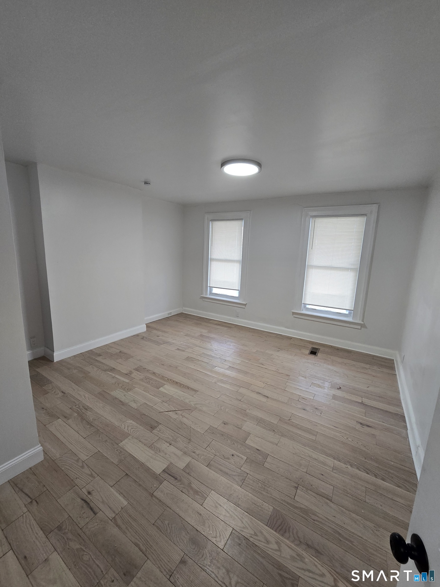 80 Dickerman Street New Haven, CT 06511 - Photo 6 of 31 an empty room with wooden floor and windows