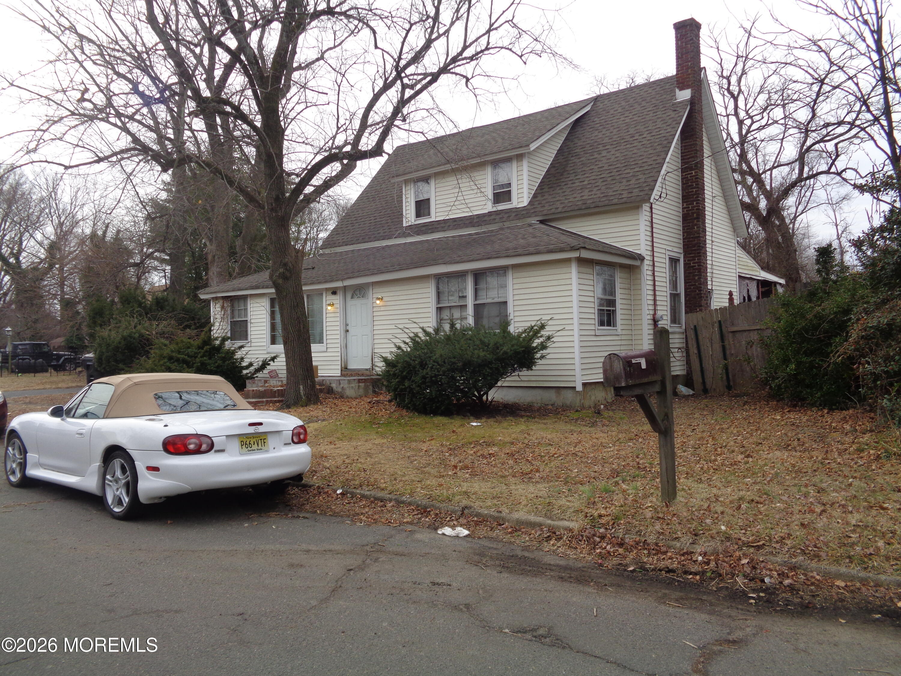 509 Henry Place Middletown, NJ 07748 - Photo 2 of 2 a white house covered with tall trees