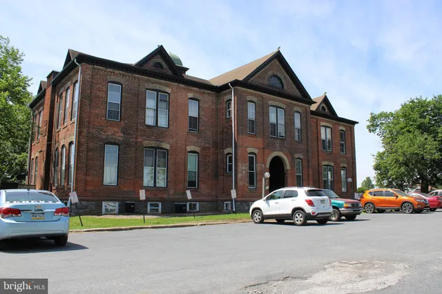 a car parked in front of a brick house