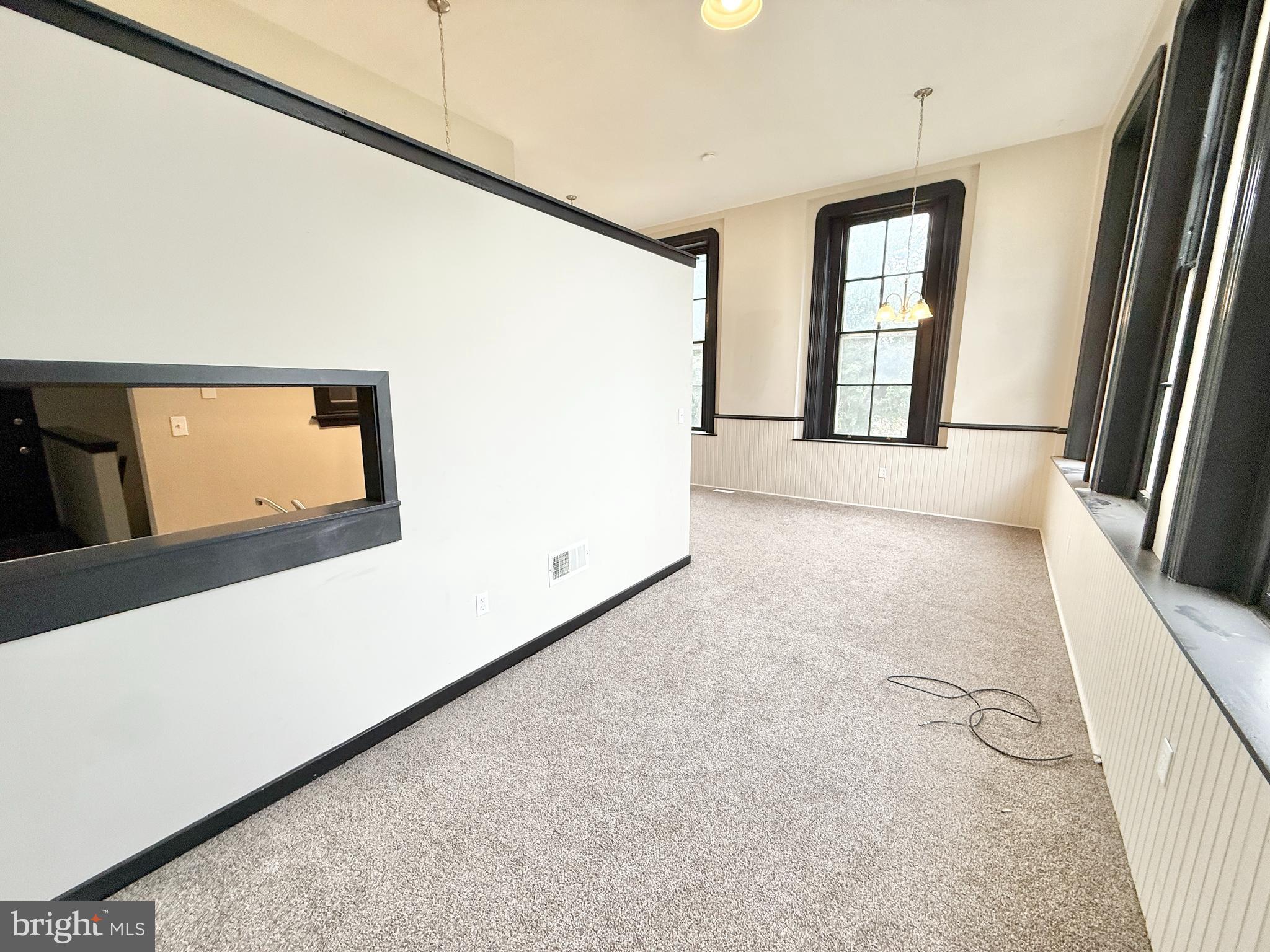 745 Manor Street, Unit 2 Columbia, PA 17512 - Photo 6 of 13 a view of a big room with windows and stairs