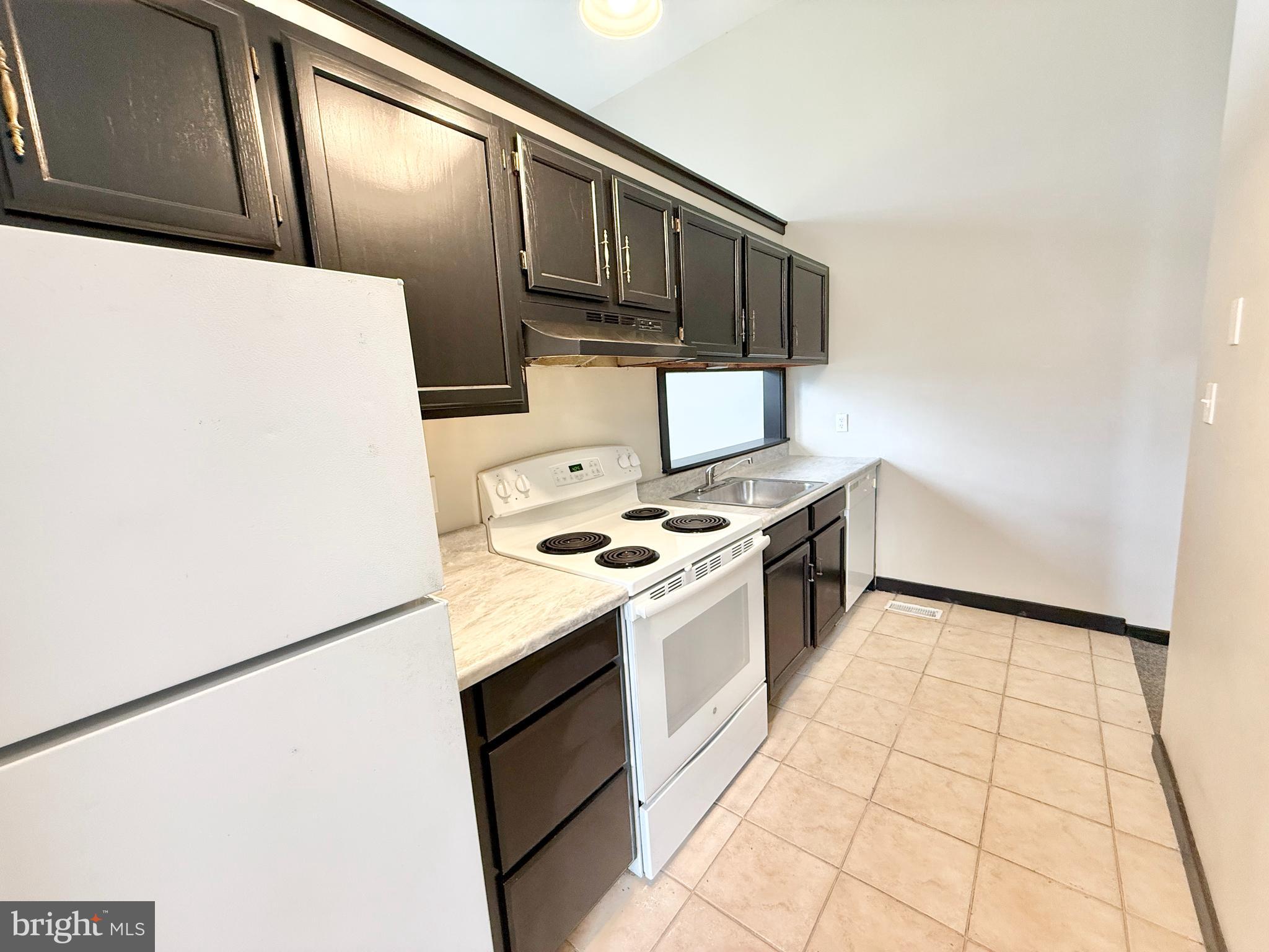 745 Manor Street, Unit 2 Columbia, PA 17512 - Photo 7 of 13 a kitchen with a stove top oven and white countertops