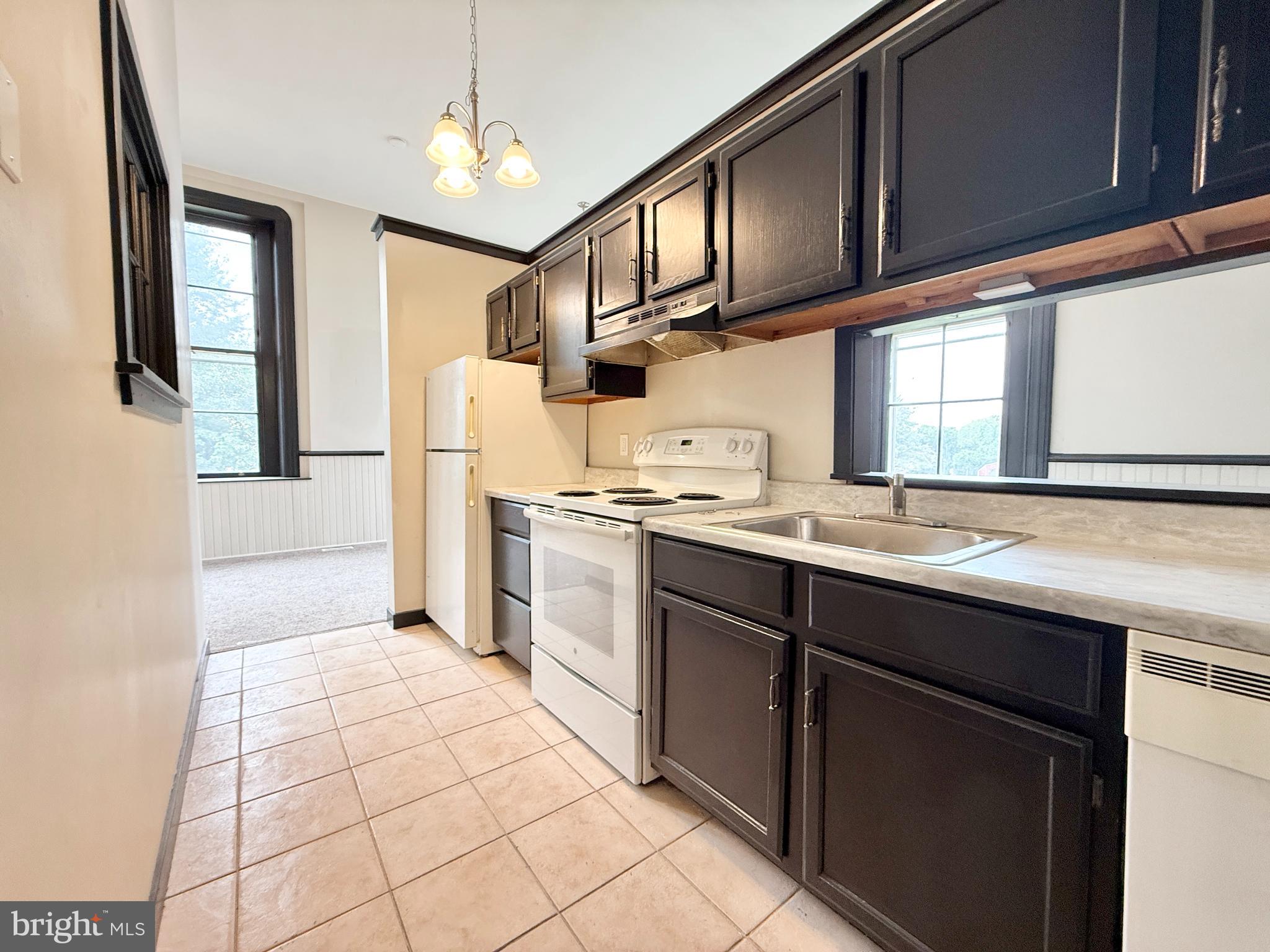 745 Manor Street, Unit 2 Columbia, PA 17512 - Photo 8 of 13 a kitchen with stainless steel appliances granite countertop a refrigerator and a sink