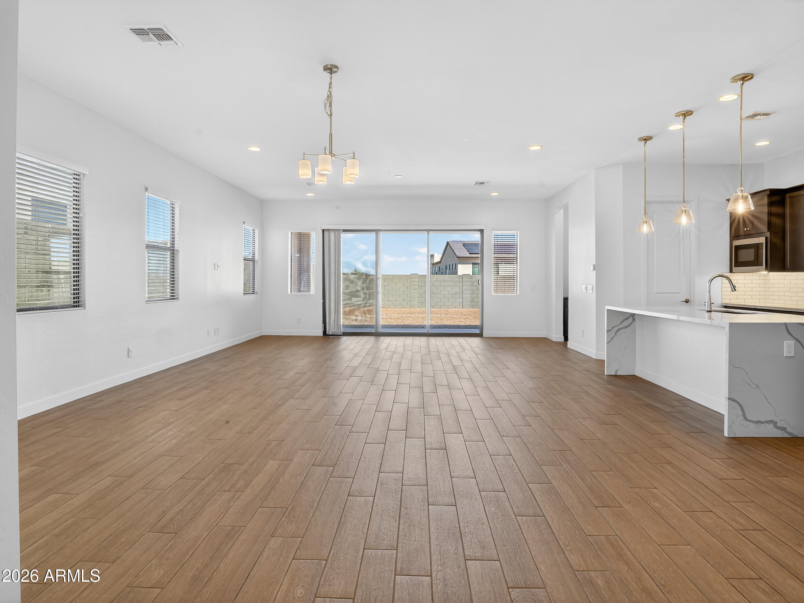 810 East Hopi Trail Phoenix, AZ 85042 - Photo 4 of 48 a view of an empty room with wooden floor and a window