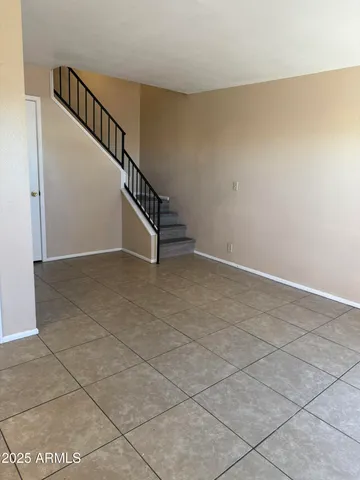 a view of an empty room with stairs