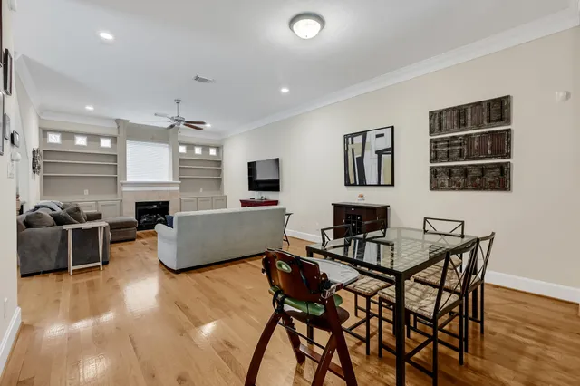 a large kitchen with stainless steel appliances a large counter top a stove and a refrigerator