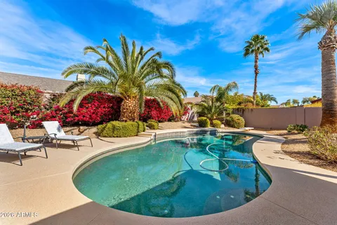 a swimming pool with outdoor seating and yard