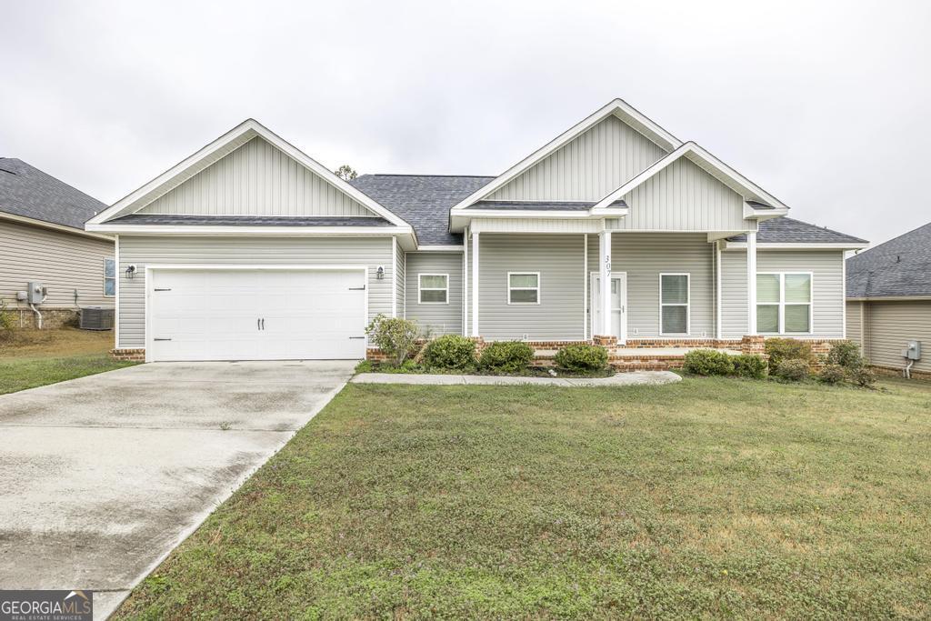 307 Ledford Way Bonaire, GA 31005 - Photo 1 of 1 a view of a yard in front of a house with a large tree