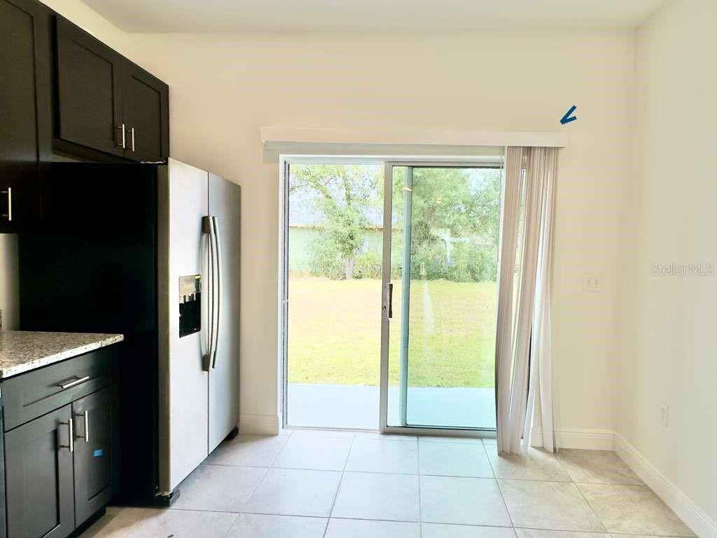 15885 Southwest 35th Court Road, Unit 2 Ocala, FL 34473 - Photo 7 of 21 a view of a kitchen with an empty space and a window