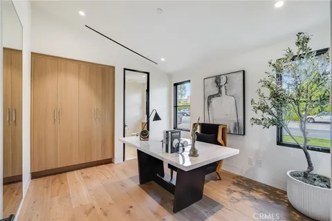 a living room with furniture and floor to ceiling windows