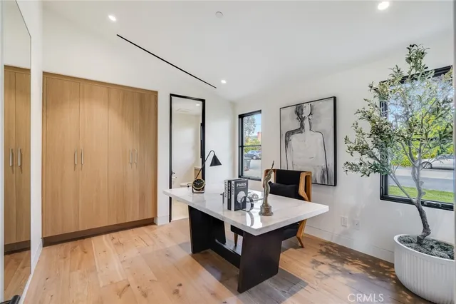 a living room with furniture and floor to ceiling windows