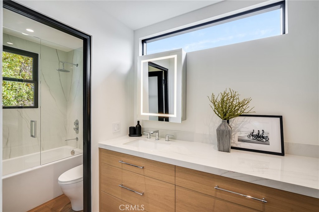 427 Santa Ana Avenue Newport Beach, CA 92663 - Photo 25 of 32 a bathroom with a sink a mirror and a toilet