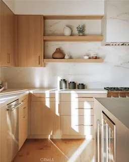 a kitchen with stainless steel appliances granite countertop a stove and wooden cabinets