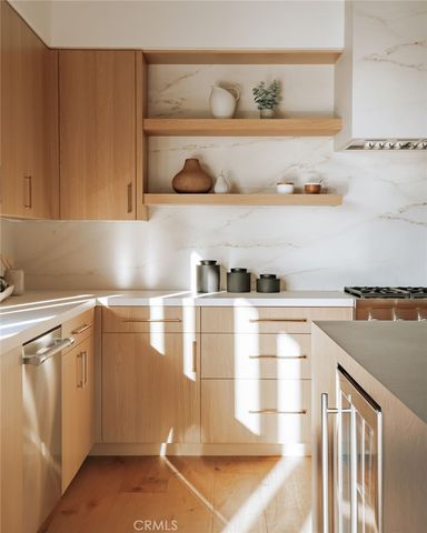 a kitchen with stainless steel appliances granite countertop a stove and wooden cabinets