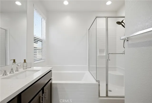 a bathroom with a granite countertop sink a toilet and shower