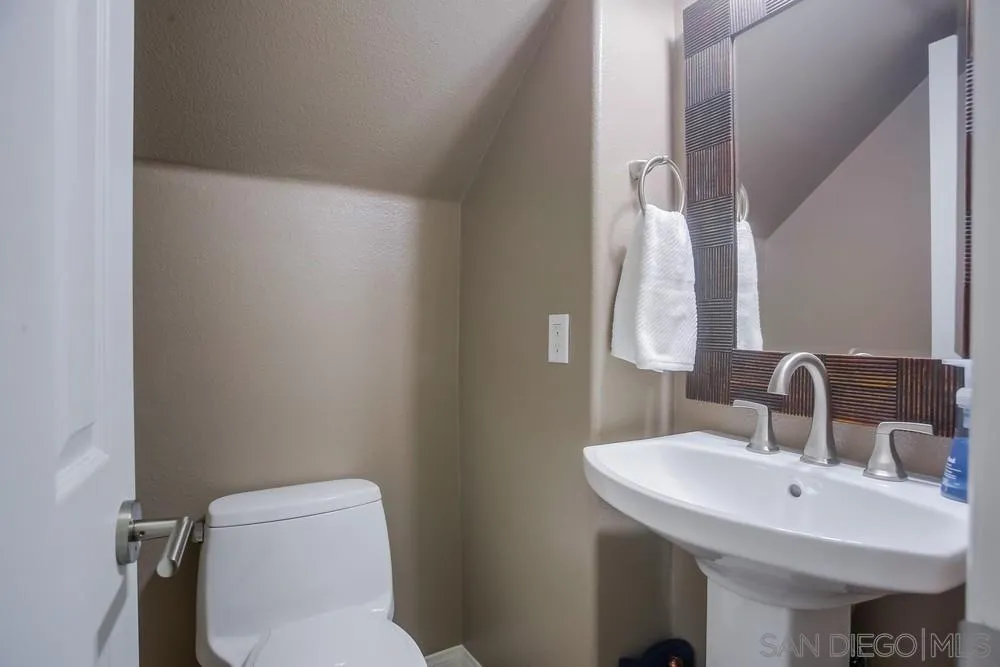 4115 Karst Road Carlsbad, CA 92010 - Photo 12 of 43 a bathroom with a toilet sink and mirror