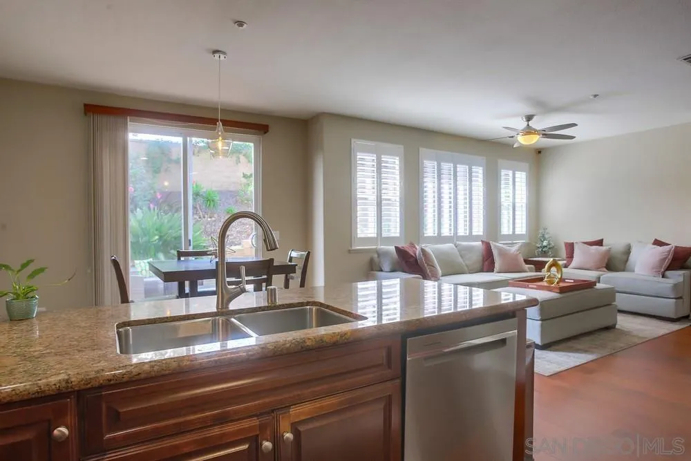 4115 Karst Road Carlsbad, CA 92010 - Photo 13 of 43 a kitchen with a stove a sink and a wooden cabinets