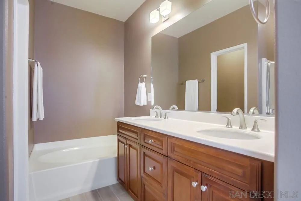 4115 Karst Road Carlsbad, CA 92010 - Photo 25 of 43 a bathroom with a tub sink and mirror