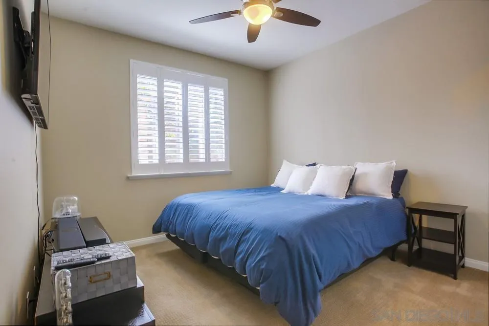 4115 Karst Road Carlsbad, CA 92010 - Photo 28 of 43 a bedroom with a bed and a chandelier