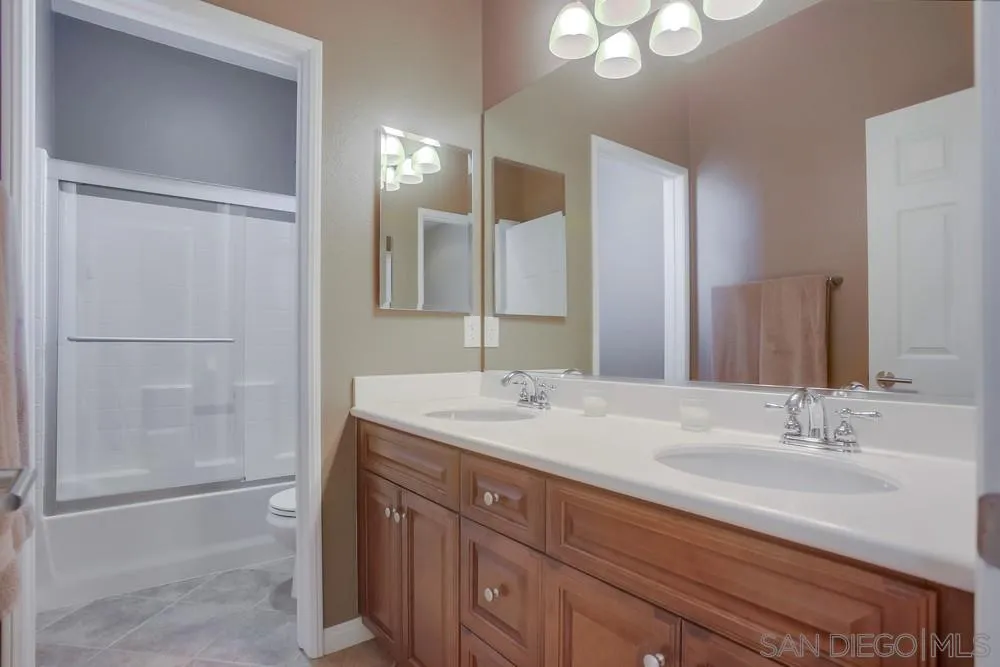 4115 Karst Road Carlsbad, CA 92010 - Photo 29 of 43 a bathroom with a sink double vanity and shower