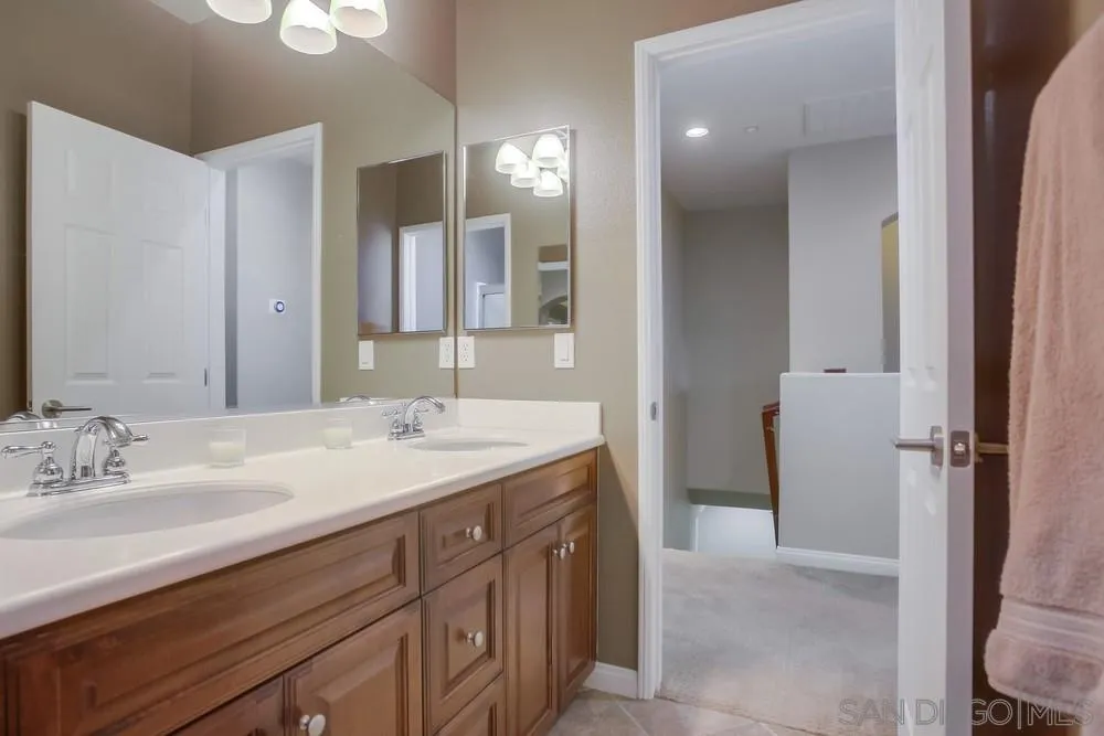4115 Karst Road Carlsbad, CA 92010 - Photo 30 of 43 a bathroom with a sink a vanity and a mirror