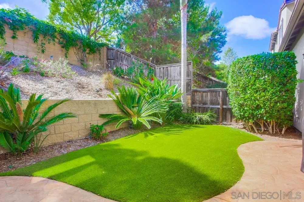 4115 Karst Road Carlsbad, CA 92010 - Photo 35 of 43 a view of a backyard with plants and a bench