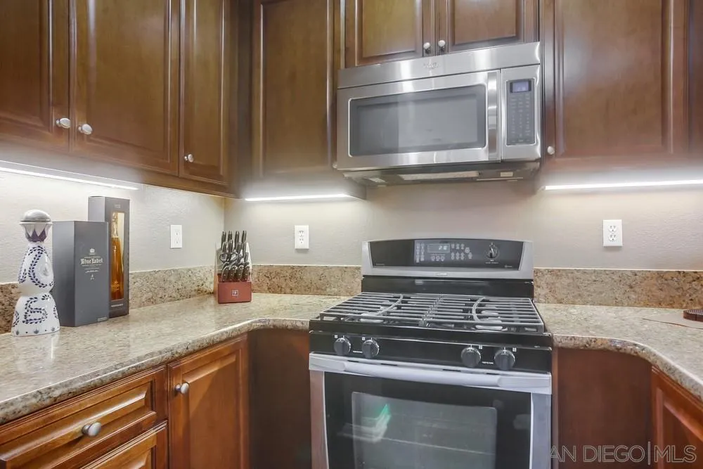 4115 Karst Road Carlsbad, CA 92010 - Photo 7 of 43 a kitchen with stainless steel appliances granite countertop a stove and a microwave