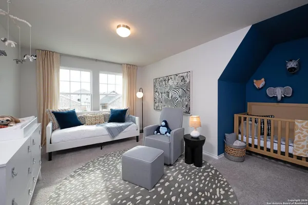 a bedroom with furniture and a large window