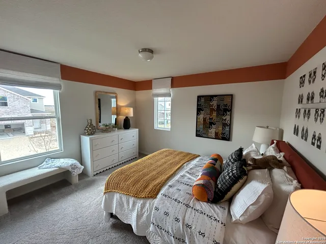 a bedroom with a bed and a couch