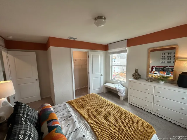 a bedroom with a bed and a lamp on table